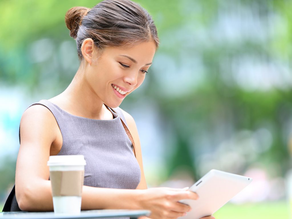 Image of a woman looking at her tablet