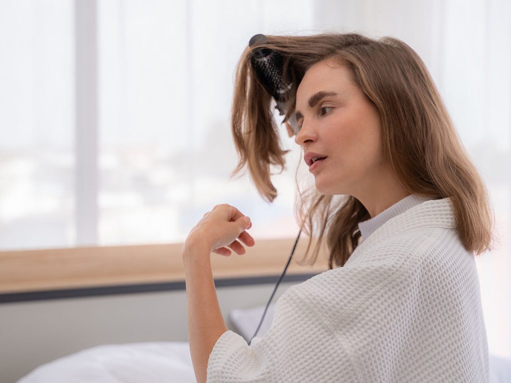 Image of a woman curling her hair